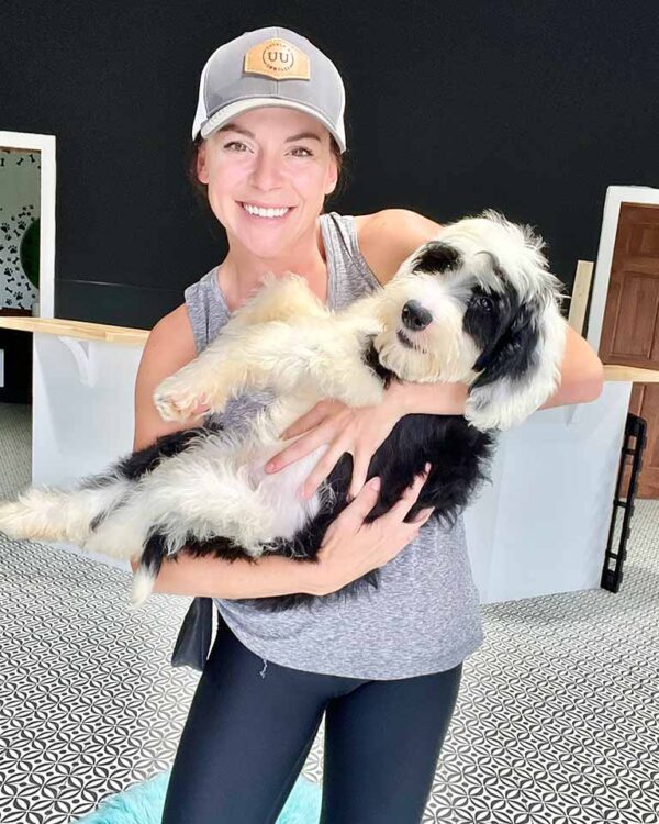 Woman holding a Sheepadoodle