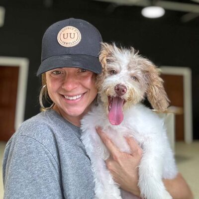 ethical Bernedoodle breeder holding one of her puppies